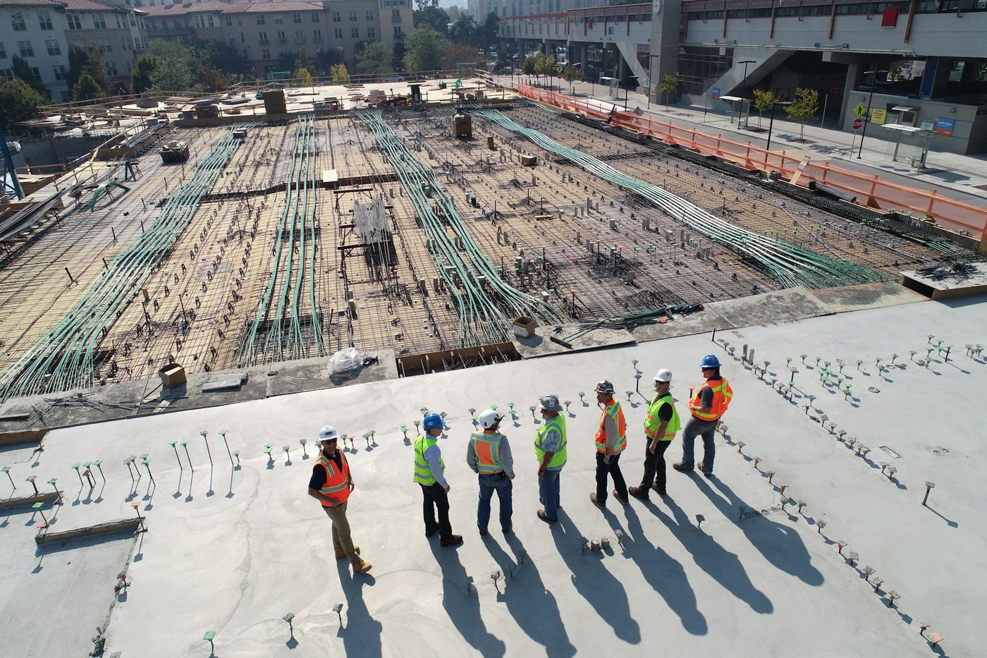 Commercial construction site with crew reviewing the slab