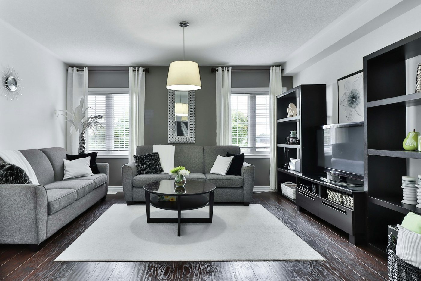 Renovated living room with grey sofa and built-in cabinetry