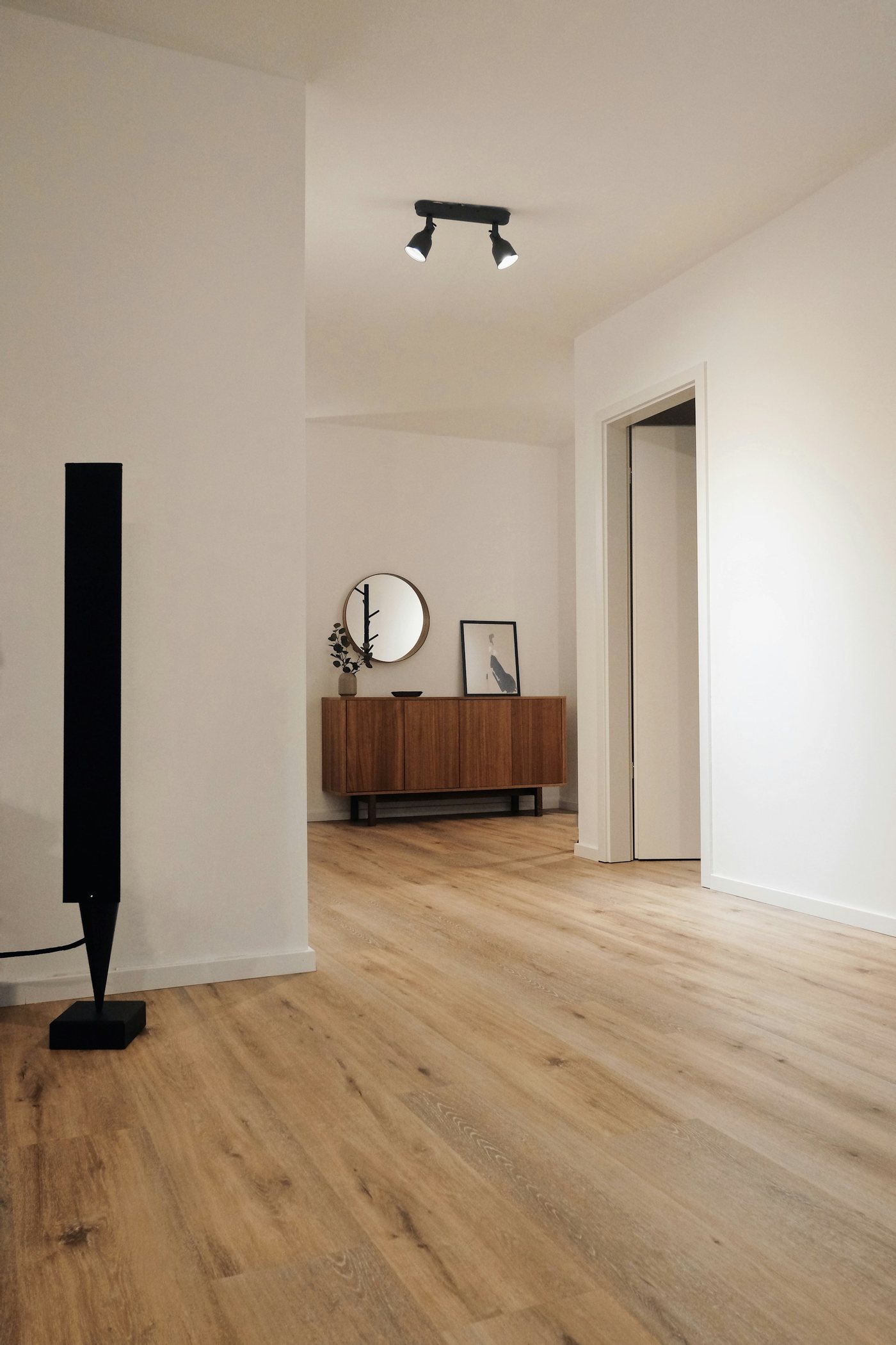 Bright finished basement room with engineered wood floor